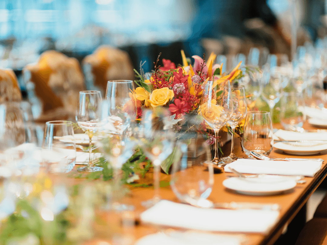 A banquet table set with florals, glassware and place settings