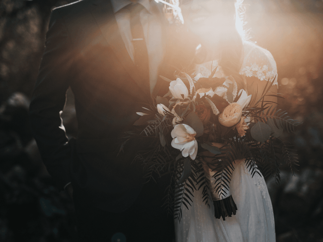 A couple with a bouquet at golden hour — the kind of moment a portfolio is made of